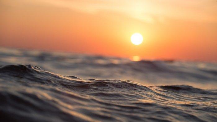 Ilustrasi sunset di lautan lepas.