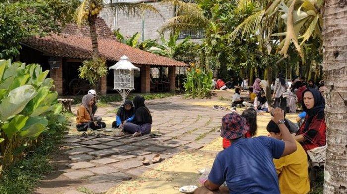 Para pengunjung duduk lesehan di tepi sawah Warung Kopi Klotok, Sleman, Jogja, Rabu (22/1/2020). Pengunjung bisa duduk di dalam rumah joglo maupun di luar dengan cara lesehan tikar.