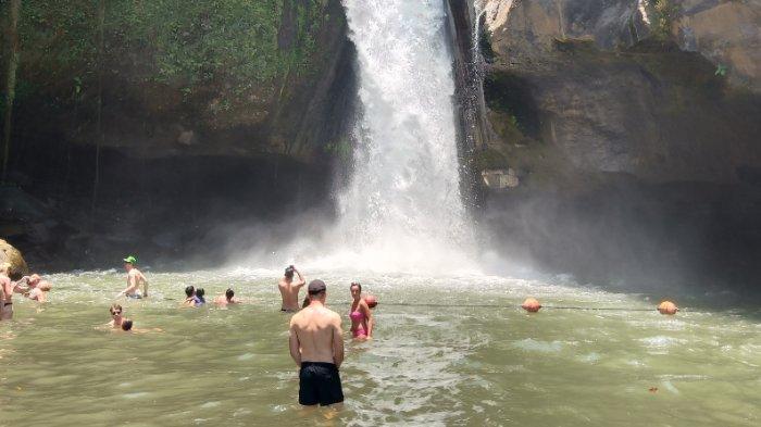Wisatawan mandi di area Air Terjun Tegenungan, Gianyar, Bali