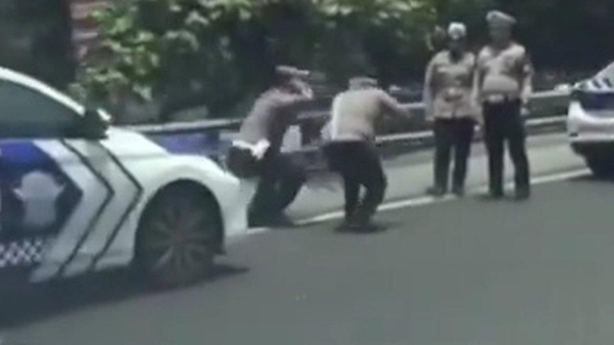 Dua anggota polisi tengah squat jump di dekat Gerbang Tol (GT) Slipi 1, Slipi, Palmerah, Jakarta Barat