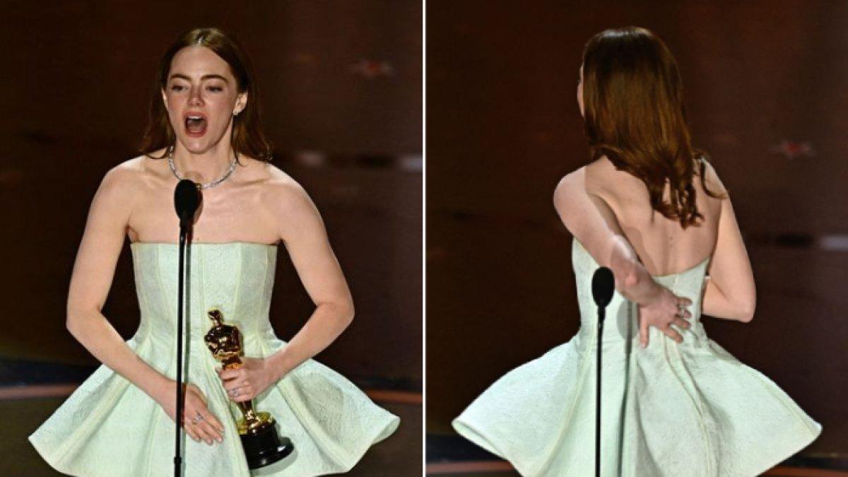 Aktris Emma Stone menunjukkan ristsleting bajunya yang rusak saat menerima penghargaan Aktris Terbaik di ajang penghargaan Oscar 2024 di Los Angeles, Amerika Serikat, Minggu (10/3/2024) malam waktu setempat.