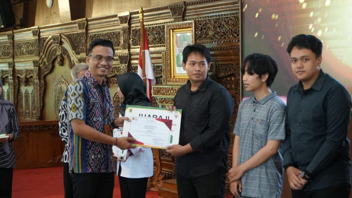 LOMBA KRENOVA KLATEN - Kepala Bapperida Klaten Pandu Wirabangsa secara simbolis menyerahkan hadiah kepada pemenang Ajang Lomba Kreativitas dan Inovasi (Krenova) Klaten 2025, Kamis (15/05/2025), di Pendopo Pemkab Klaten.