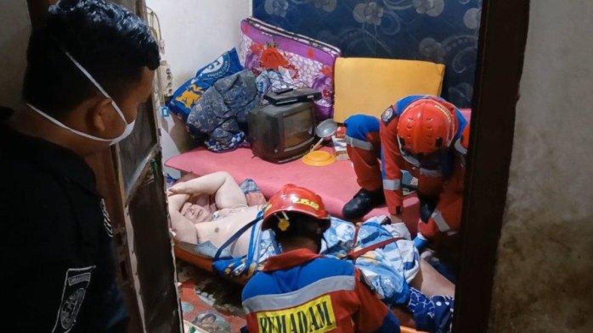 Petugas pemadam kebakaran mengevakuasi pria obesitas seberat 200 kilogram dari indekos di Pademangan, Jakarta Utara, Minggu (26/11/2023)
