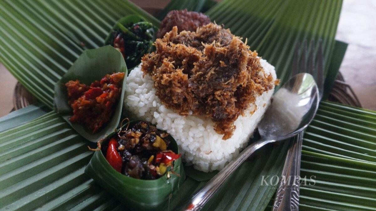 Menu nasi nyangku dengan lauk daging sapi bertabur serundeng, sayur oseng tempe hitam, sayur pakis, sambal, dan tempe bacem dapat dinikmati di rumah makan Oemah Nyangku, Desa Karangsalam, Kecamatan Baturraden, Kabupaten Banyumas, Jawa Tengah, Sabtu (1/10/2022).