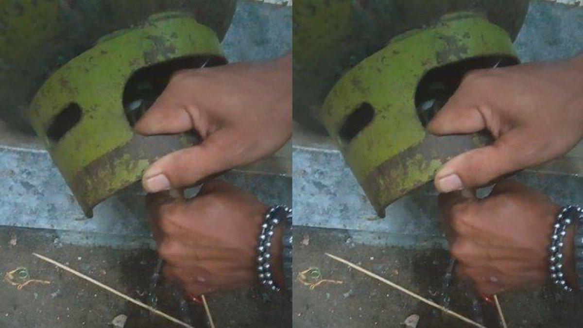 Viral video aksi pasutri tengah mengeluarkan isi tabung gas elpiji 3 kg yang mereka sebut berisi air bukan gas. (Facebook)
