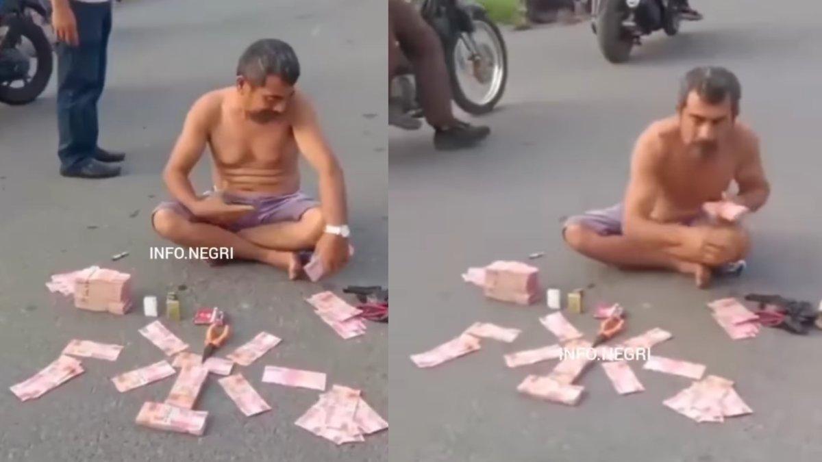 Viral video aksi pria memamerkan uang Rp350 juta di tengah jalan.
