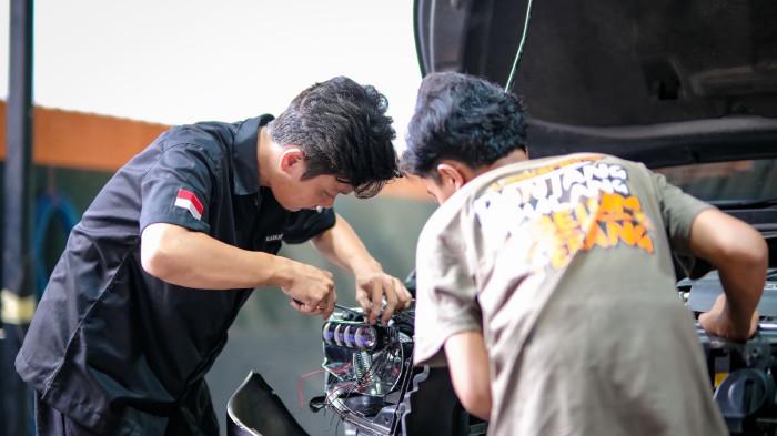 MODIFIKASI - Aktivitas instalasi lampu kendaraan di Yoong Motor di Surabaya.