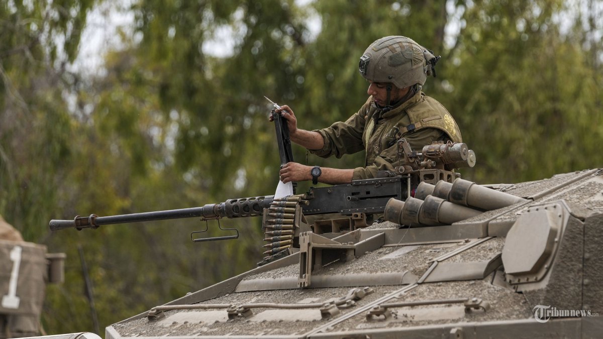 Seorang tentara Israel bekerja di tank di tempat persiapan dekat perbatasan Gaza Israel, Israel selatan, Senin, 9 Oktober 2023. Penguasa militan Hamas di Jalur Gaza melakukan serangan multi-front yang belum pernah terjadi sebelumnya terhadap Israel saat fajar menyingsing hari Sabtu , menembakkan ribuan roket ketika puluhan pejuang Hamas menyusup ke perbatasan yang dijaga ketat di beberapa lokasi, menewaskan ratusan orang dan menawan. Pejabat kesehatan Palestina melaporkan sejumlah kematian akibat serangan udara Israel di Gaza. (AP Photo/Tsafrir Abayov)