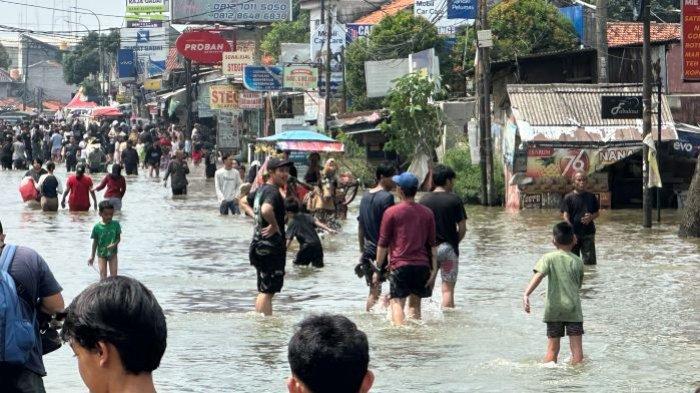 BANJIR - Kuda yang menarik gerobak penumpang alias delman, tidak khawatir untuk menerjang banjir di Jalan Raya Cipondoh, Tangerang, Selasa siang (8/7/2025)/ Danang Triatmojo