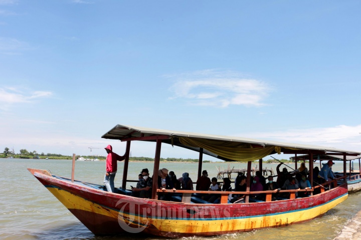 Sejumlah wisatawan sedang menaiki prahu wisata di Pantai Marina Semarang, Jawa Tengah, Kamis (11/3/21). Pengunjung cukup membayar 10 ribu untuk bisa menaiki perahu untuk mengelilingi kawasan Pantai Marina yang berada di pesisir utara Pulau Jawa.