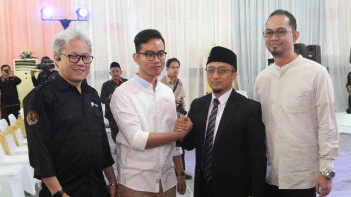 Ustaz Yusuf Mansur saat acara peluncuran aplikasi pembayaran Paytren. Tampak dia bersalaman denhgan Gibran Rakabuming Raka. 