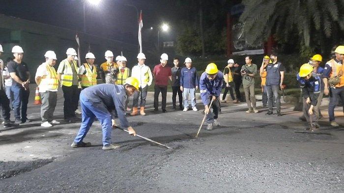 Penjabat Bupati Bekasi, Dani Ramadan meninjau proses pengaspalan berbahan plastik di Jalan Deltamas Boulevard, Cikarang Pusat, pada Kamis (8/8/2024) malam.