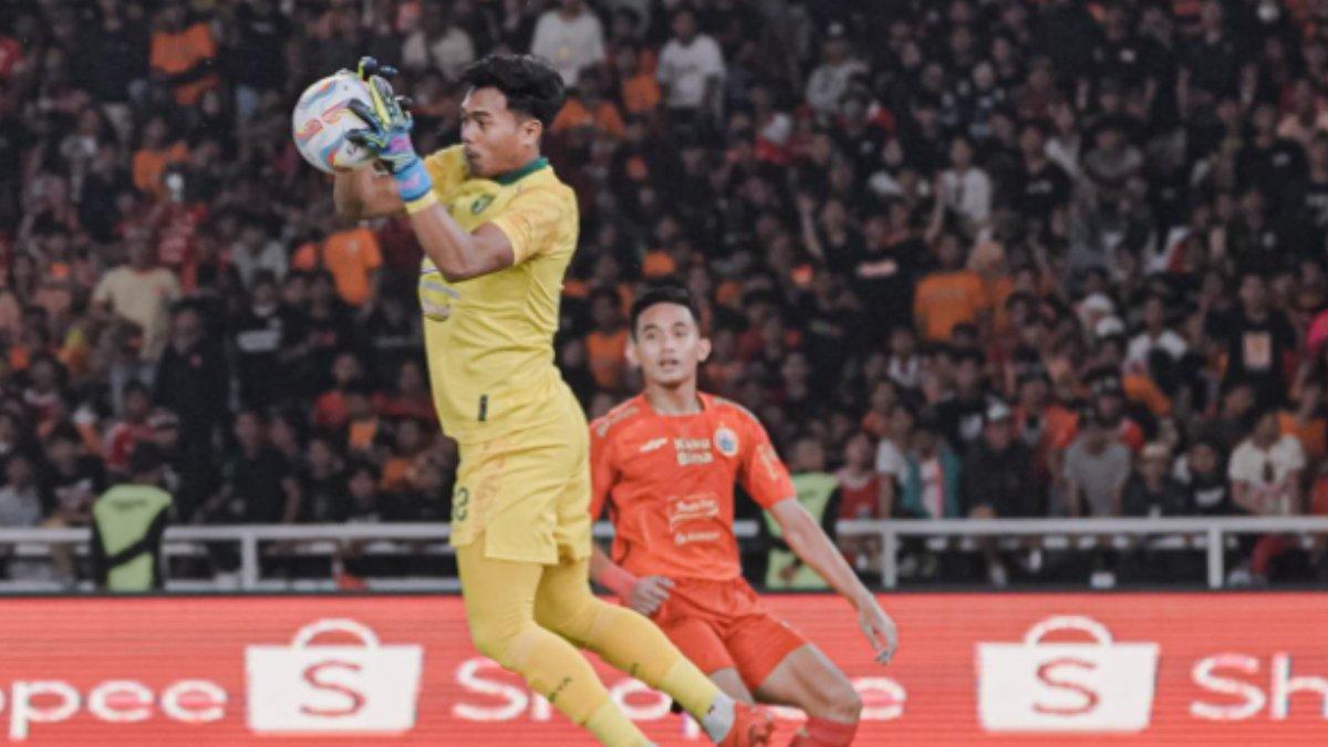 Potret Andhika Ramadhani kiper Persebaya Surabaya saat berlaga di lapangan.