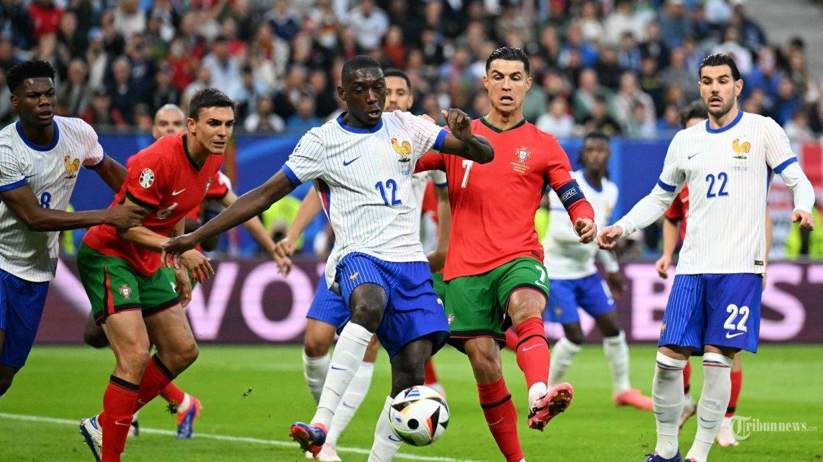 Penyerang Timnas Prancis #12 Randal Kolo Muani dan penyerang Timnas Portugal #07 Cristiano Ronaldo berebut bola. Hasil Euro 2024, Portugal kalah adu penalti dari Prancis dengan skor 3-5, Sabtu (6/7/2024).